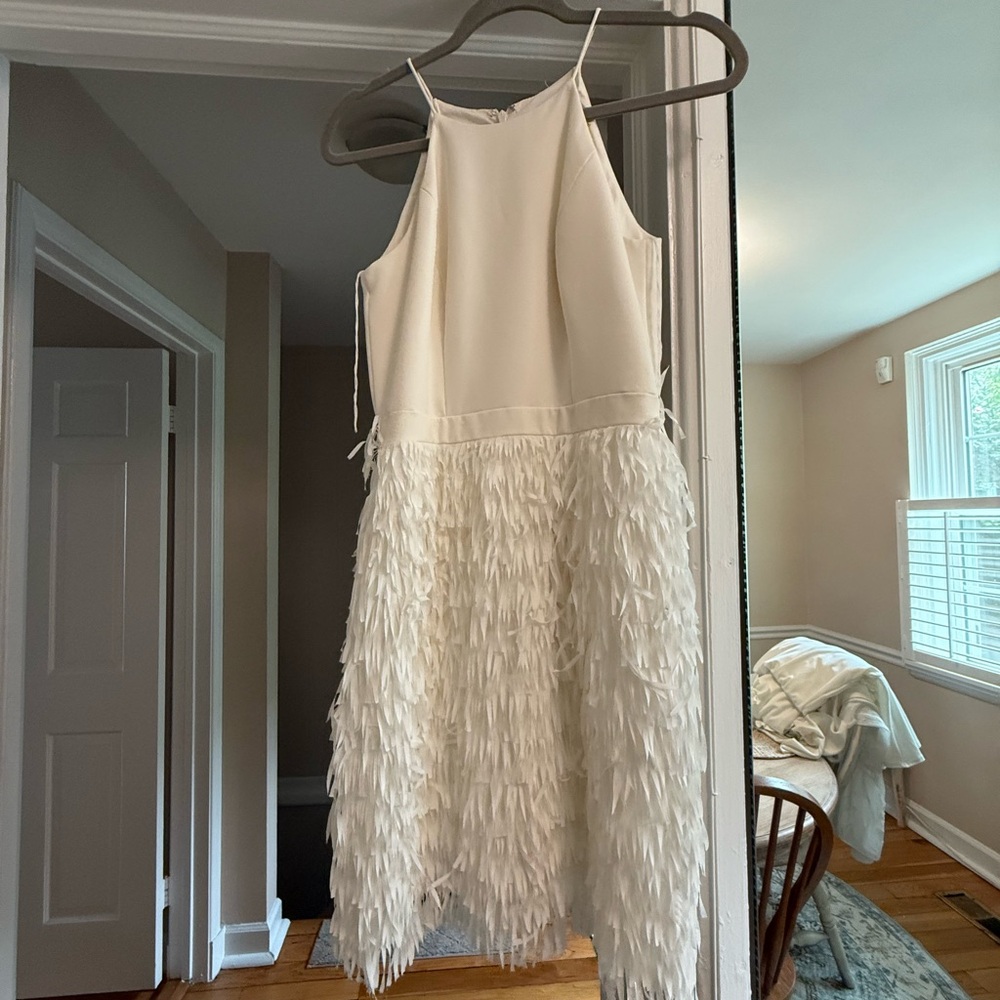 Elegant White Sleeveless Dress with Feathered Skirt